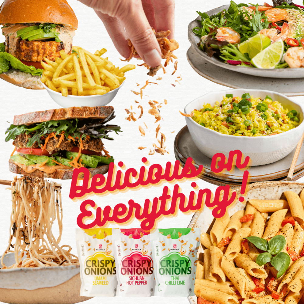 A hand sprinkling crispy fried onions onto 3 product packets, surrounded by food dishes including a burger and fries, sandwich, ramen noodles, penne pasta, fried turmeric rice, and a salad.